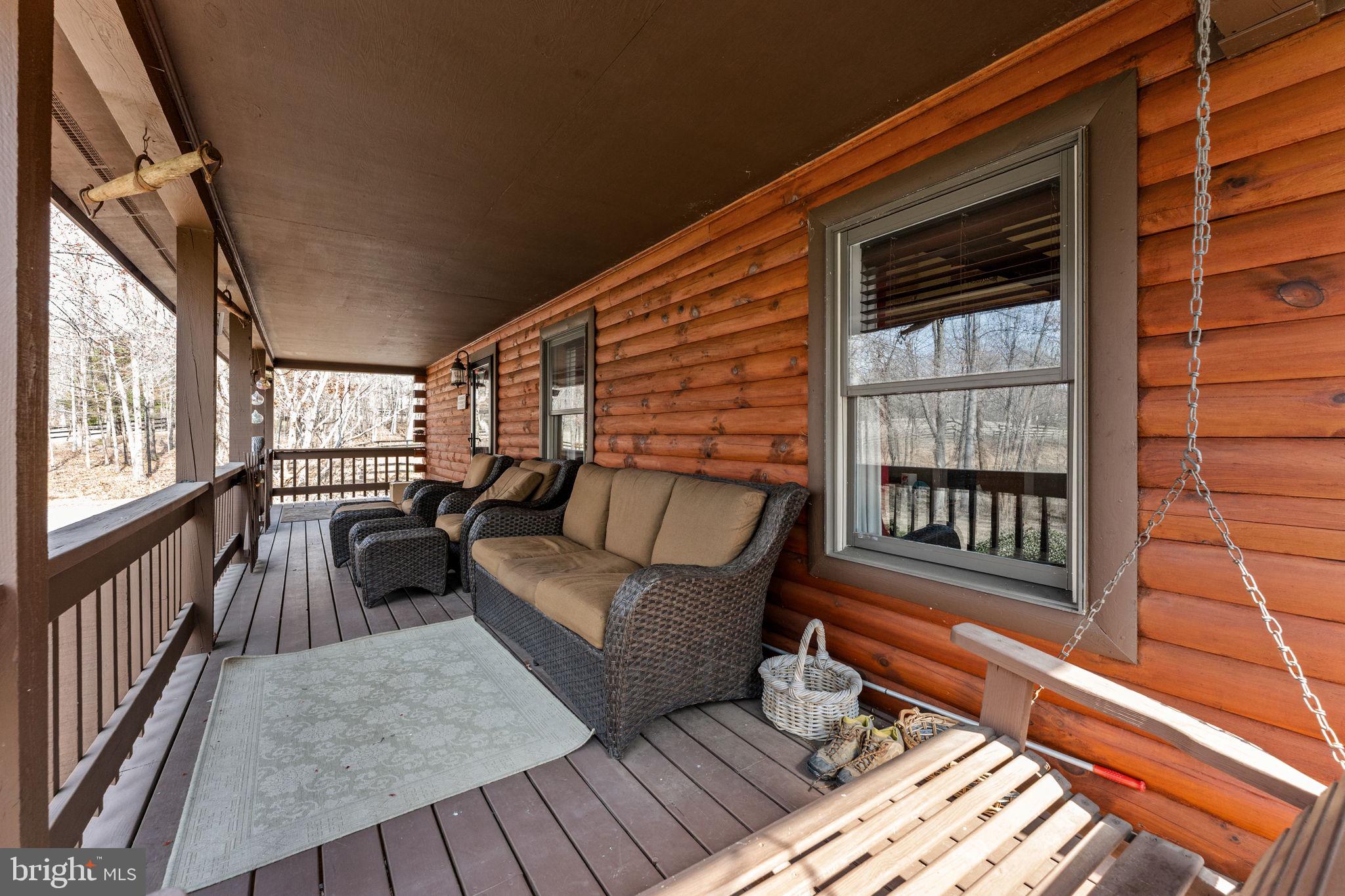 10418 Cliff Mills Road Marshall, VA 20115 - Photo 64 of 88 a balcony with wooden floor and outdoor seating