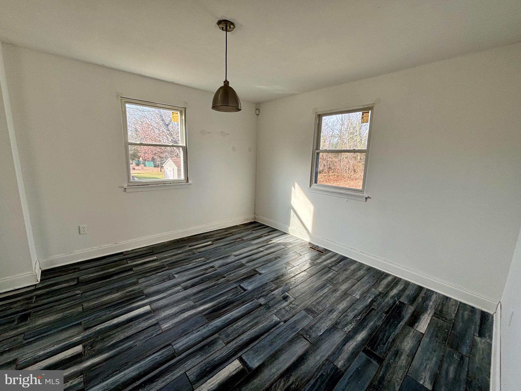 142 Oak Pines Boulevard Pemberton, NJ 08068 - Photo 4 of 17 a view of an empty room with wooden floor and a window