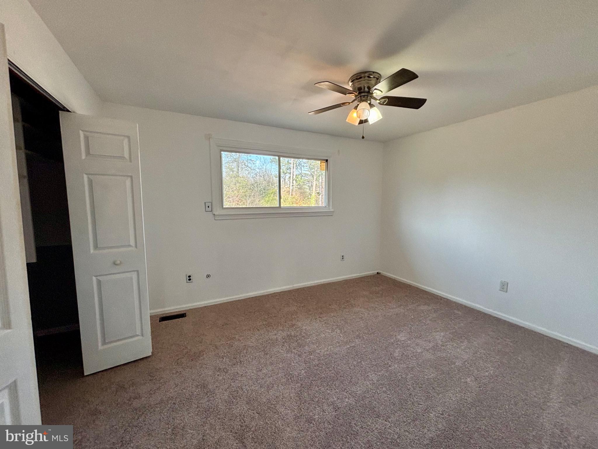 142 Oak Pines Boulevard Pemberton, NJ 08068 - Photo 9 of 17 an empty room with windows and fan