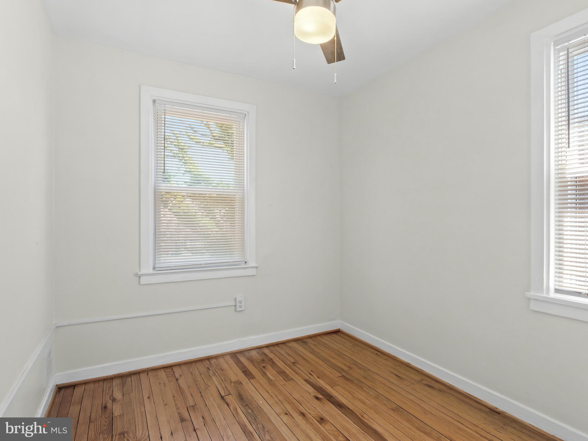 101 Upmanor Road Baltimore, MD 21229 - Photo 26 of 40 an empty room with wooden floor and windows