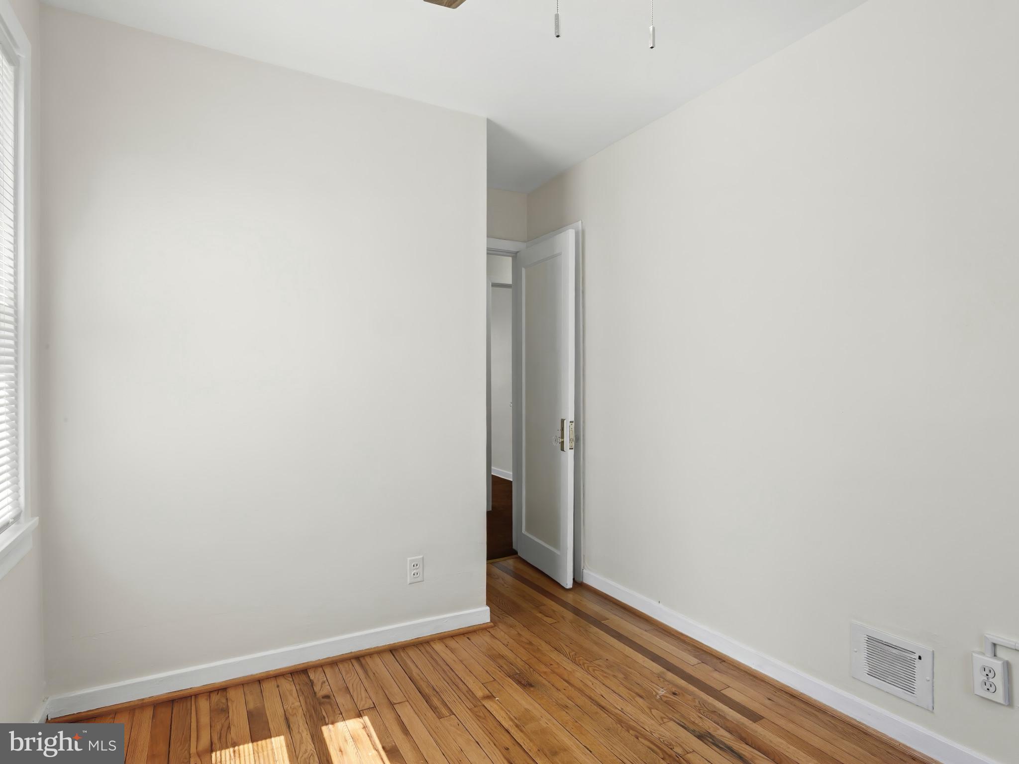 101 Upmanor Road Baltimore, MD 21229 - Photo 27 of 40 a view of an empty room with wooden floor