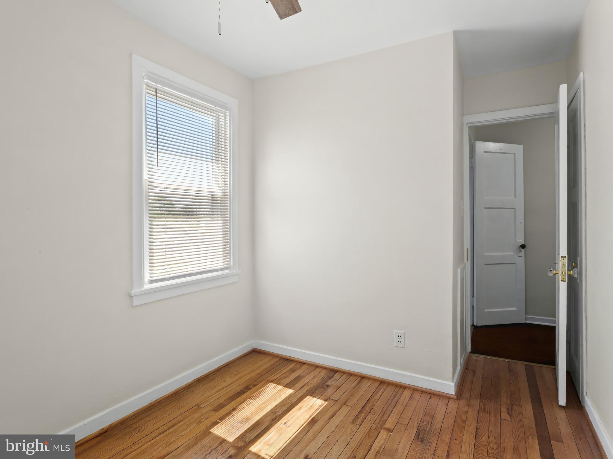 101 Upmanor Road Baltimore, MD 21229 - Photo 28 of 40 an empty room with wooden floor and windows