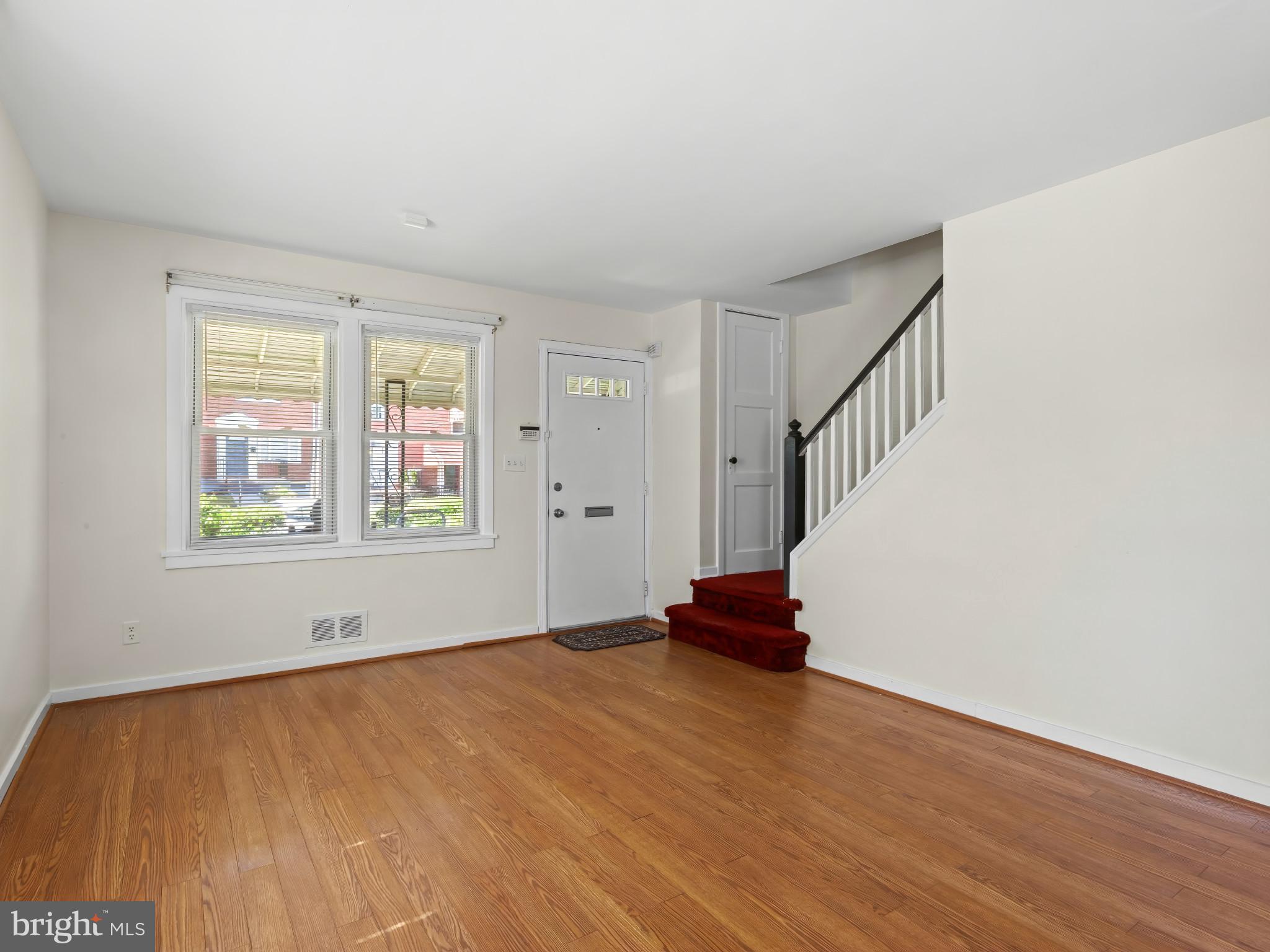 101 Upmanor Road Baltimore, MD 21229 - Photo 5 of 40 a view of empty room with wooden floor and fan