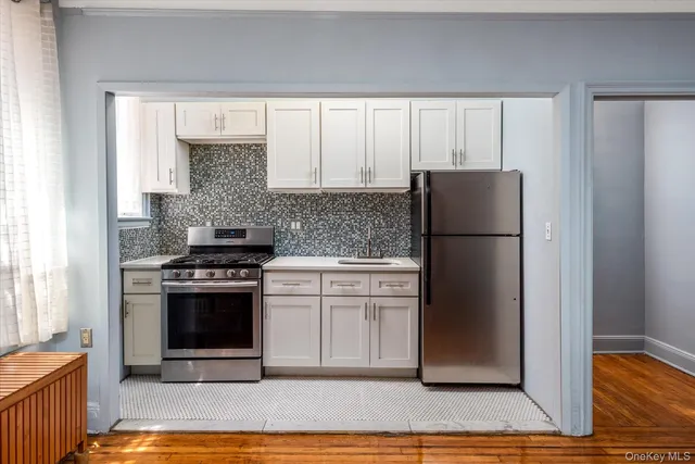 a kitchen with a refrigerator sink and cabinets