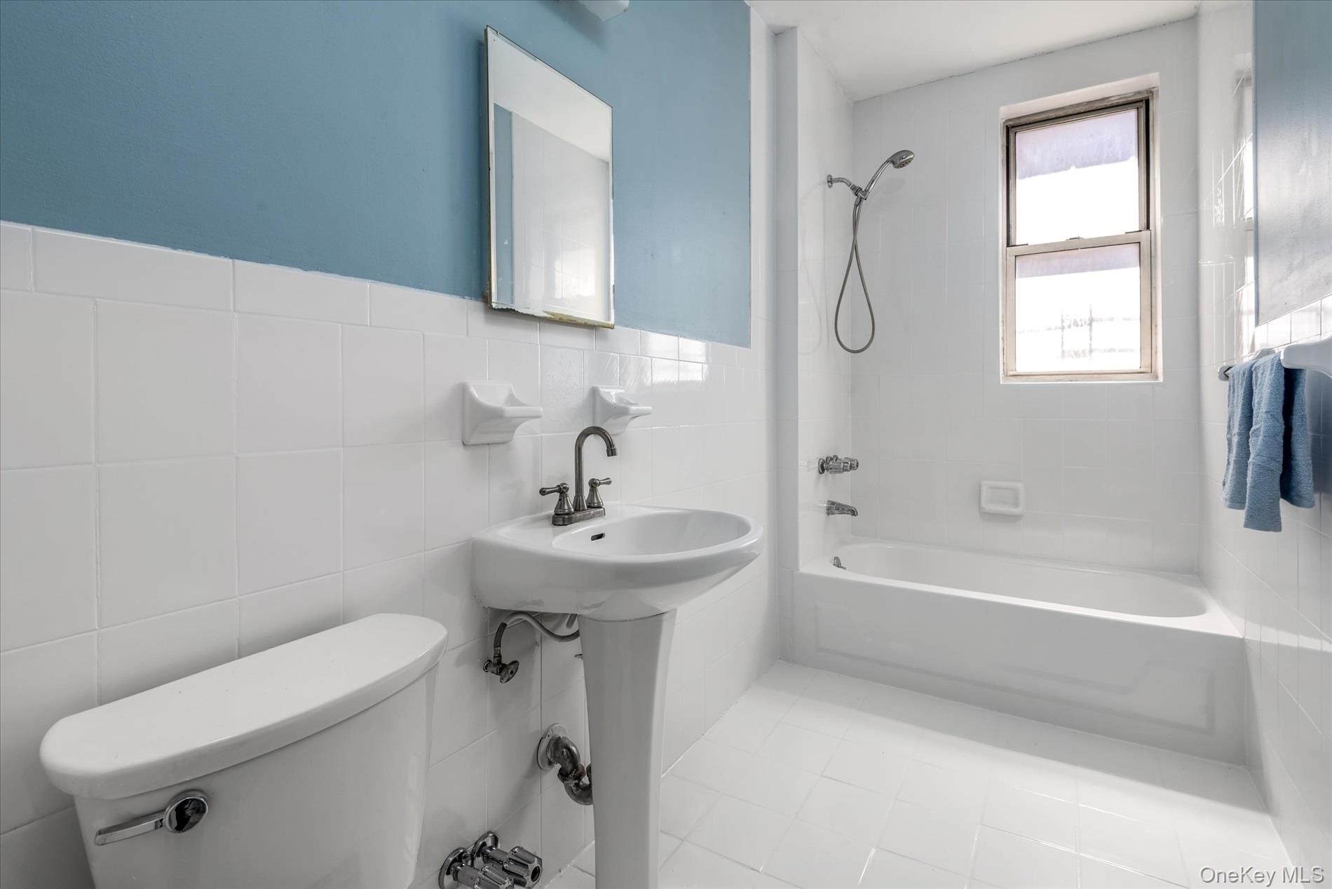 59-11 Queens Boulevard, Unit 4P Queens, NY 11377 - Photo 9 of 10 a bathroom with a sink a toilet and a bathtub