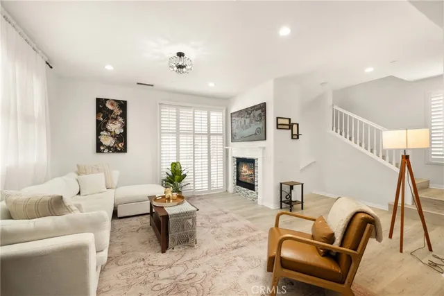 a living room with furniture a fireplace and a table