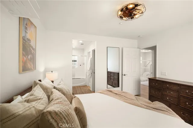 a bedroom with a bed and a dresser