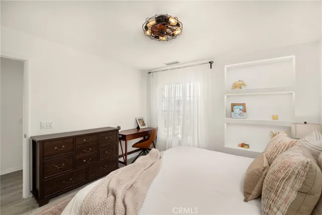 a bedroom with a bed and a dresser