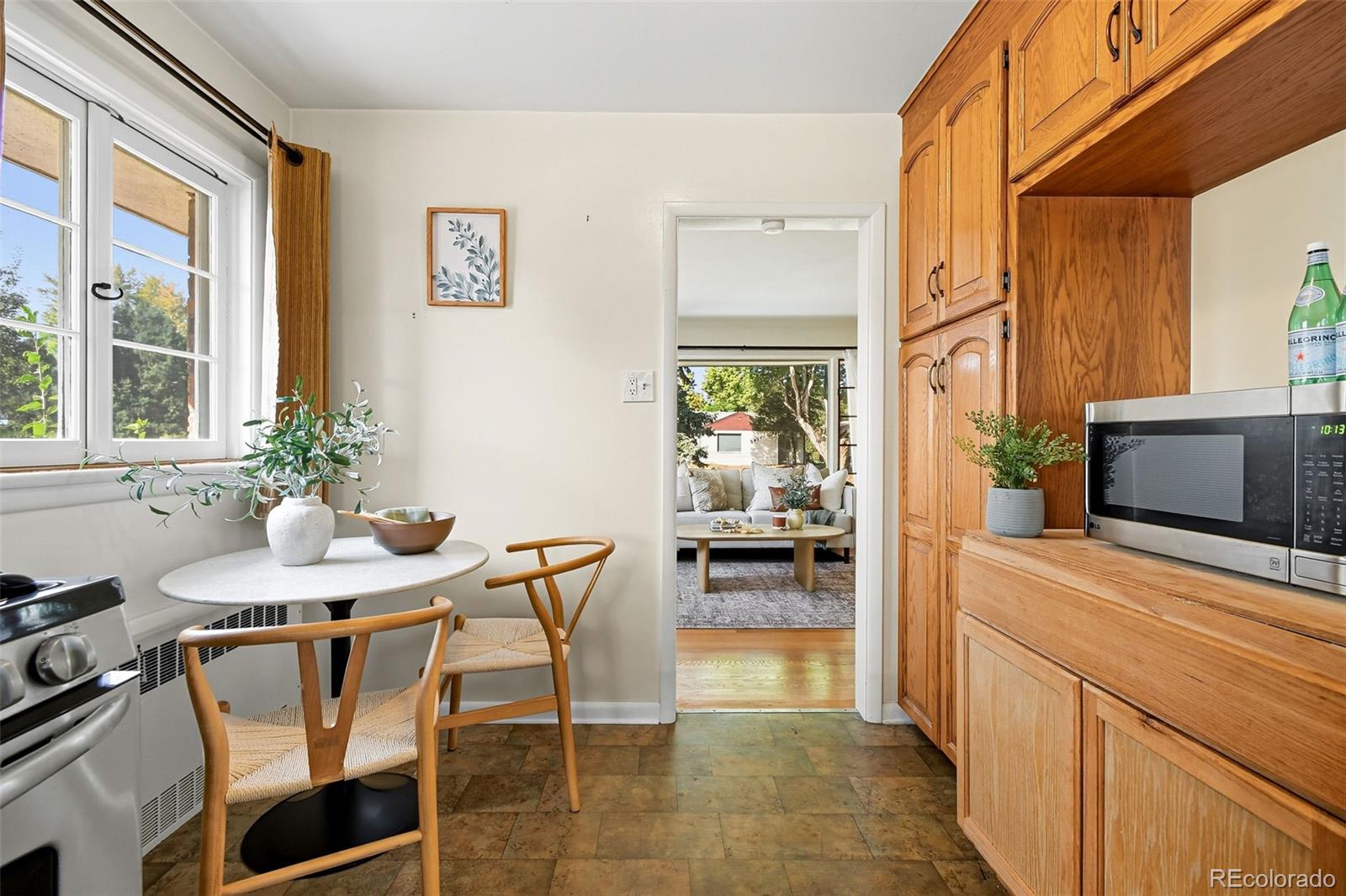 3420 Otis Street Wheat Ridge, CO 80033 - Photo 13 of 32 a kitchen with a table and chairs in it