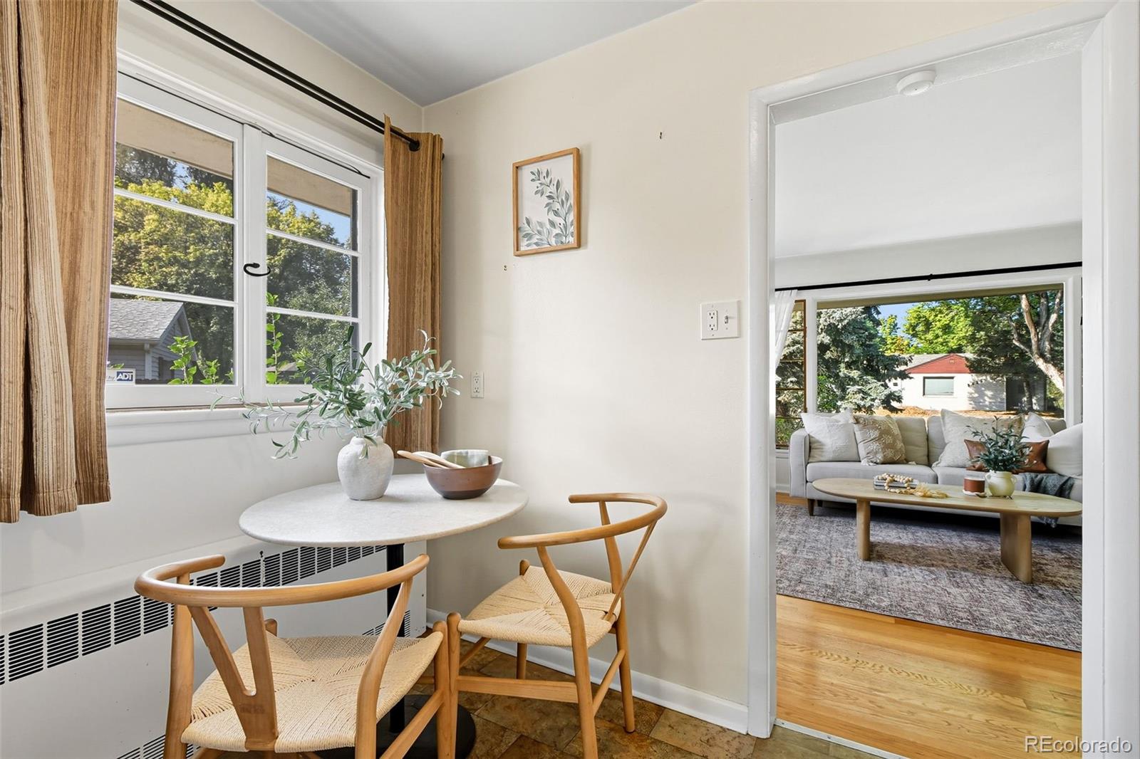 3420 Otis Street Wheat Ridge, CO 80033 - Photo 14 of 32 a dining room with furniture and a large window