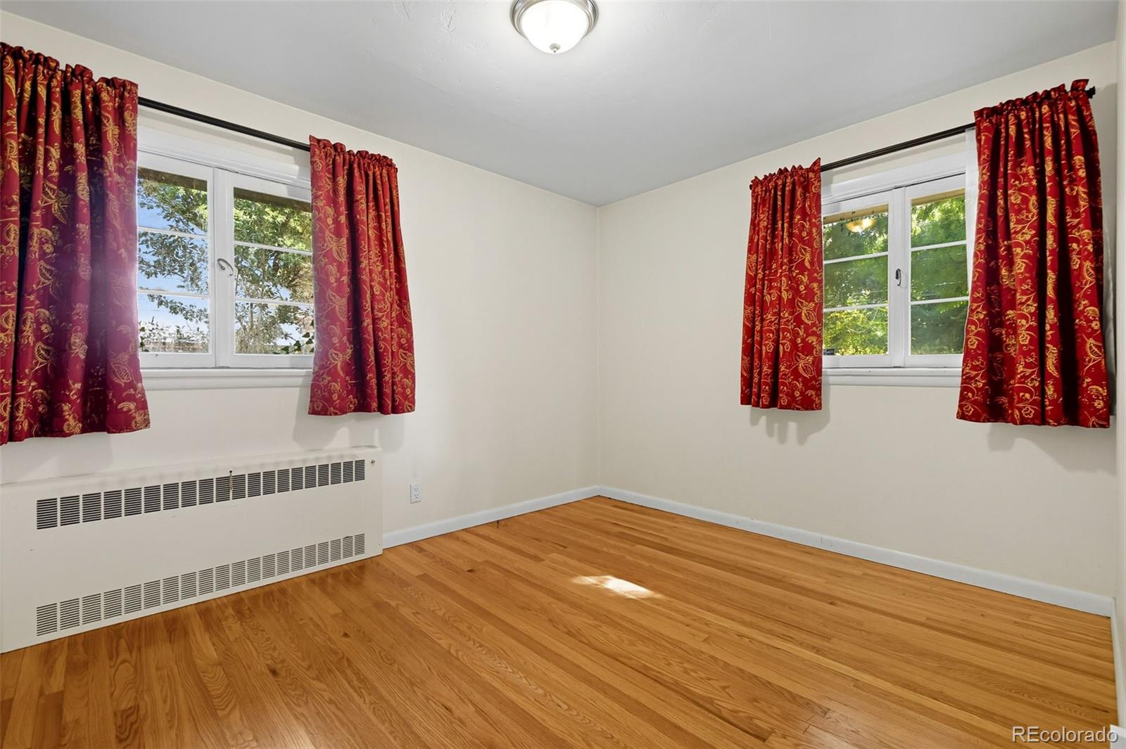 3420 Otis Street Wheat Ridge, CO 80033 - Photo 21 of 32 a view of a room with wooden floor and windows