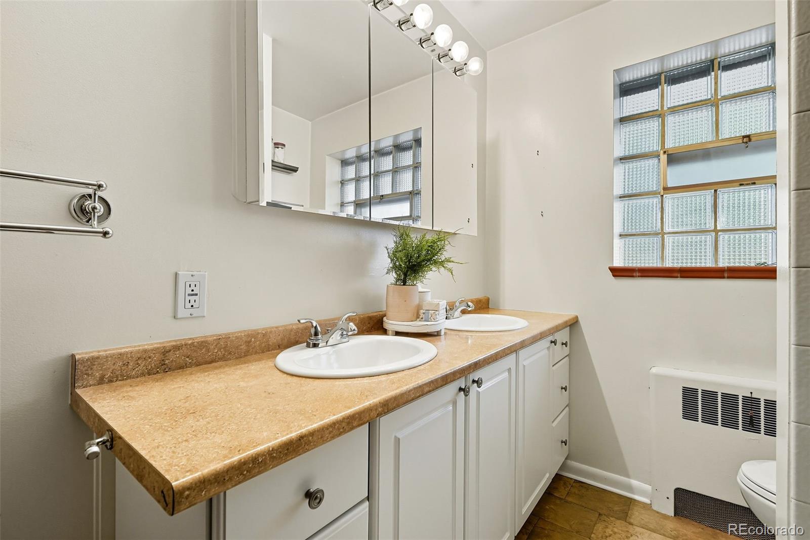 3420 Otis Street Wheat Ridge, CO 80033 - Photo 24 of 32 a bathroom with a sink a vanity and a mirror