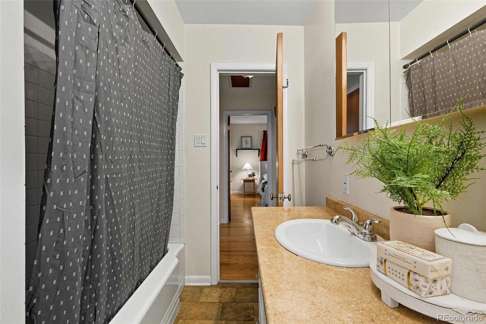 3420 Otis Street Wheat Ridge, CO 80033 - Photo 25 of 32 a bathroom with a sink and a mirror