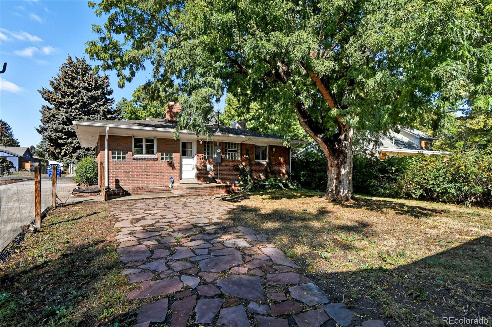 3420 Otis Street Wheat Ridge, CO 80033 - Photo 28 of 32 a view of a house with backyard and tree