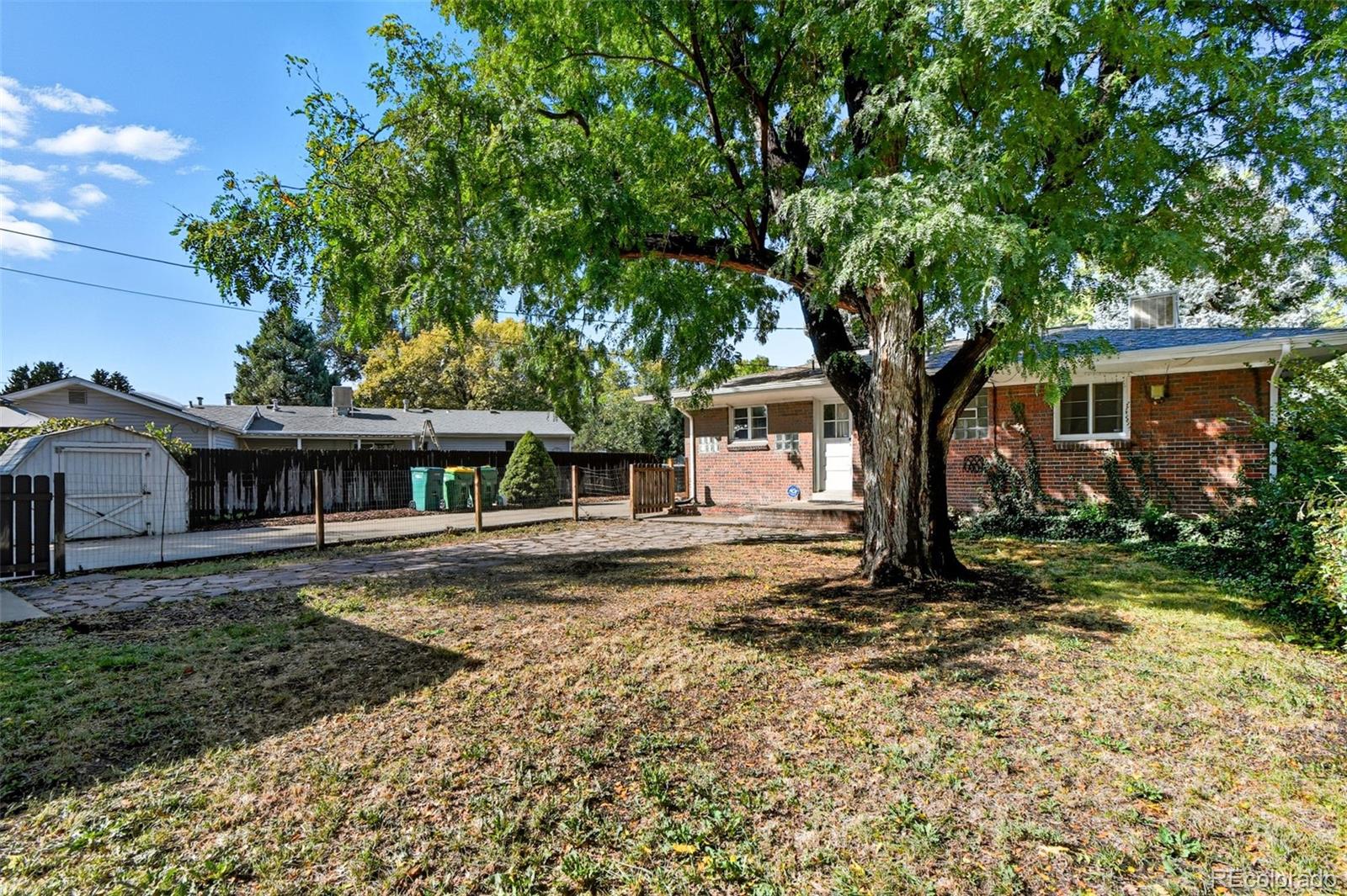 3420 Otis Street Wheat Ridge, CO 80033 - Photo 30 of 32 a view of a house with a yard
