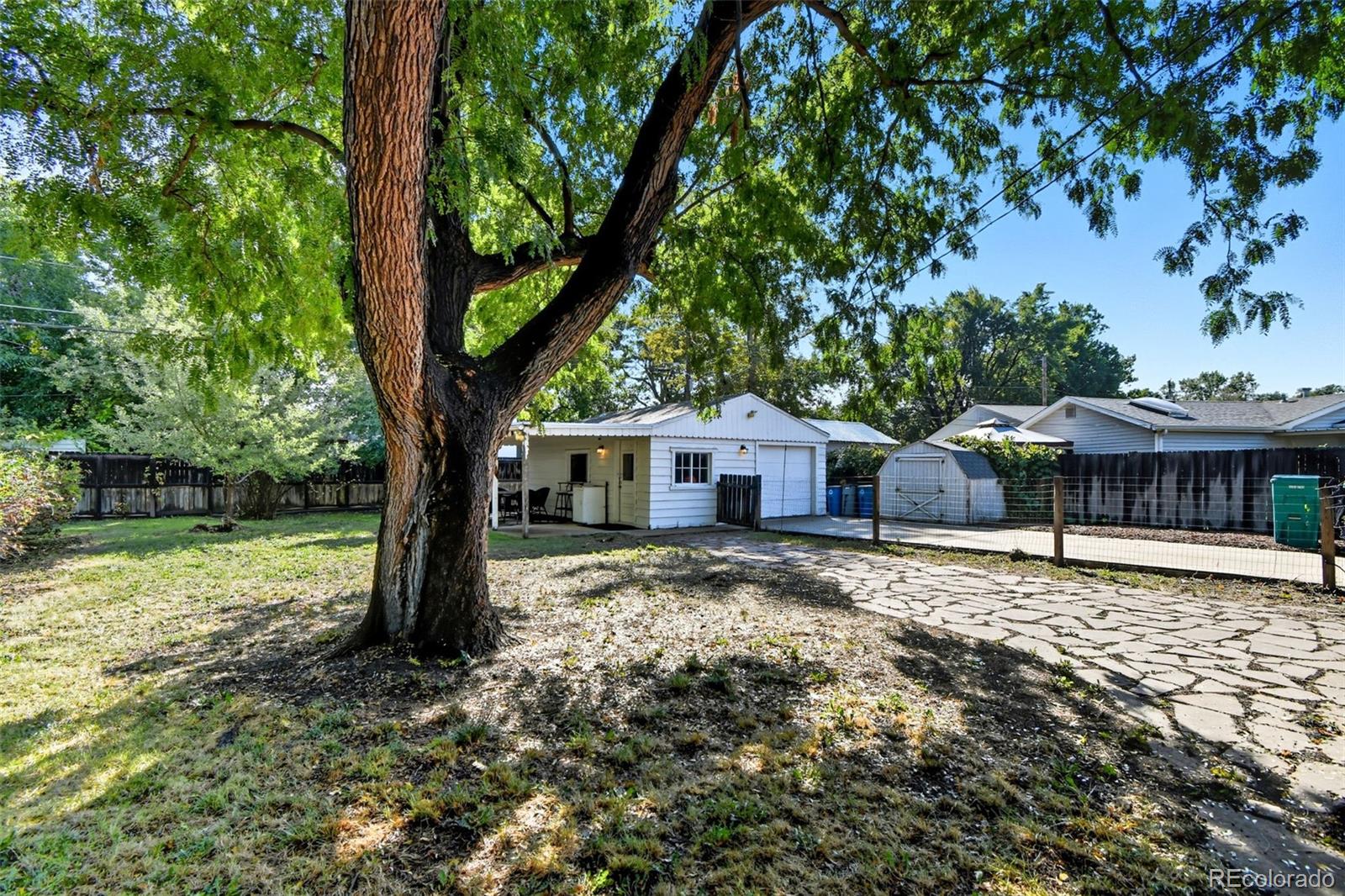 3420 Otis Street Wheat Ridge, CO 80033 - Photo 31 of 32 a house with a tree in the background