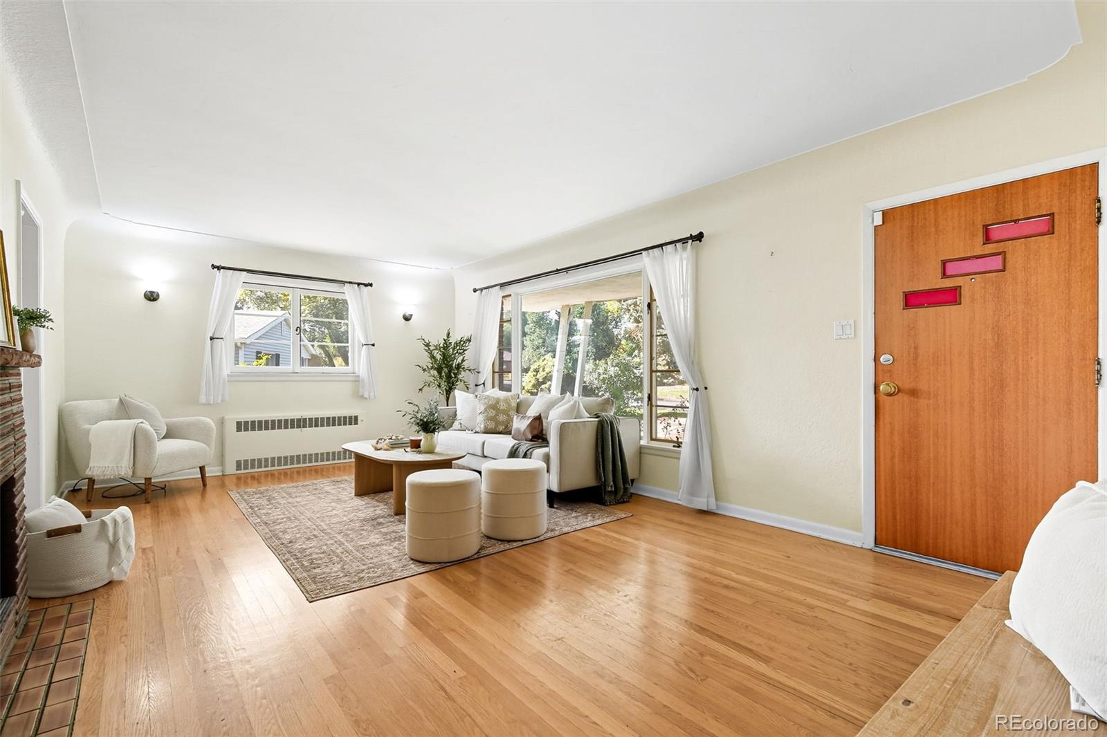 3420 Otis Street Wheat Ridge, CO 80033 - Photo 9 of 32 a living room with furniture large window and wooden floor