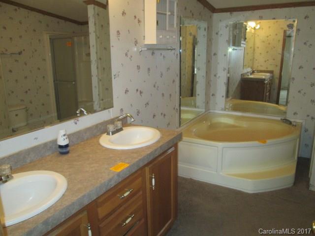 136 Asbury Road Canton, NC 28716 - Photo 14 of 24 a bathroom with a granite countertop sink and a mirror