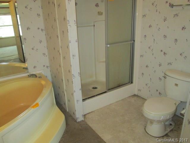 136 Asbury Road Canton, NC 28716 - Photo 15 of 24 a bathroom with a toilet and shower