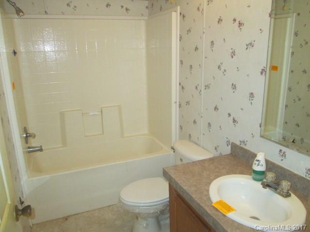 136 Asbury Road Canton, NC 28716 - Photo 18 of 24 a bathroom with a sink toilet and shower