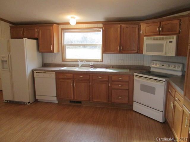 136 Asbury Road Canton, NC 28716 - Photo 9 of 24 a kitchen with a stove a sink and a refrigerator