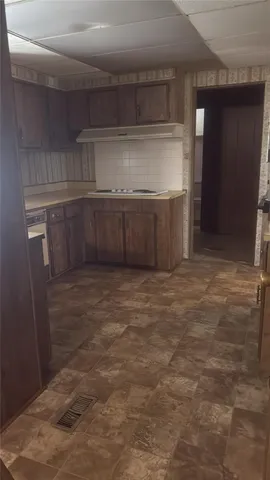 a kitchen with kitchen island a sink and refrigerator