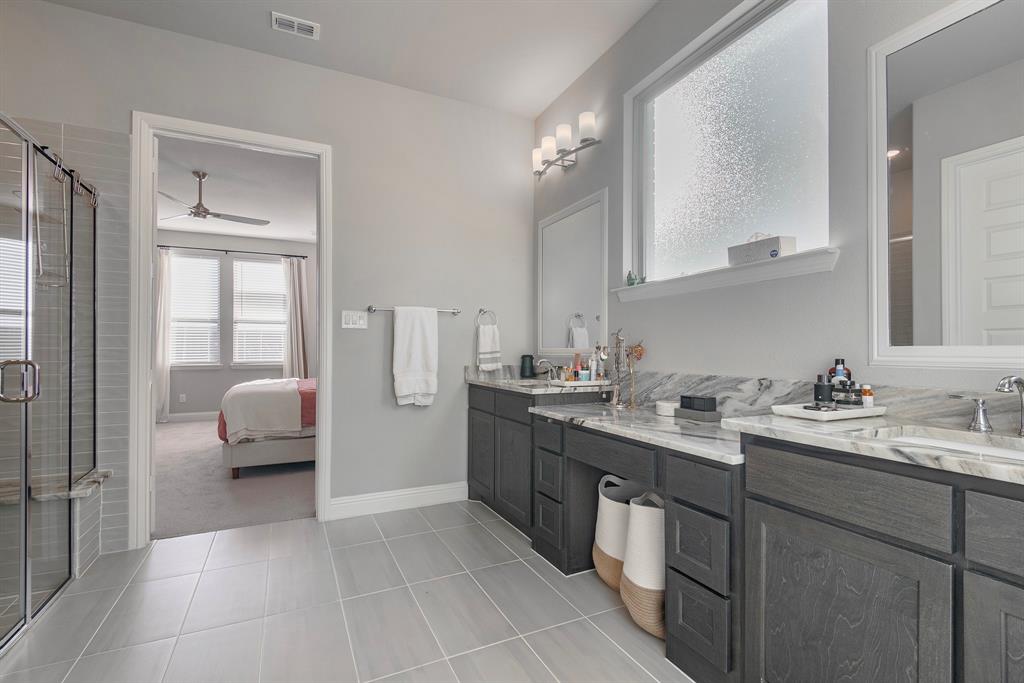16650 Nightshade Road Frisco, TX 75033 - Photo 22 of 40 a en suite bathroom with a double vanity sink and a mirror