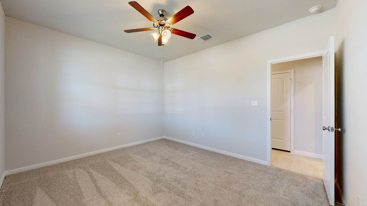 808 Gauge Road Thorndale, TX 76577 - Photo 20 of 31 A well-lit room featuring soft carpet and a versatile ceiling fan.