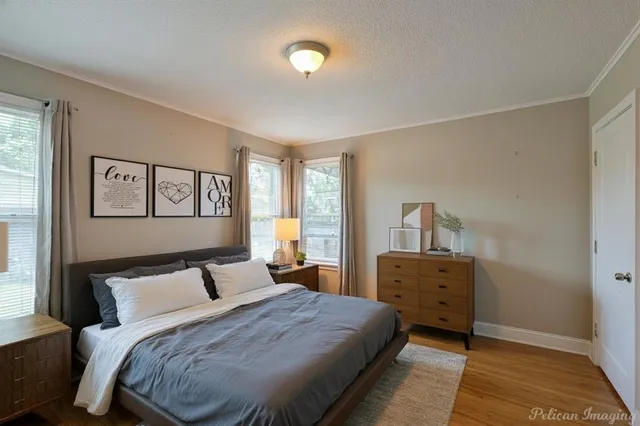a bedroom with a bed and a lamp on dresser