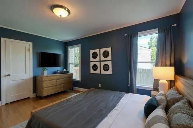 a bedroom with a bed and flat screen tv