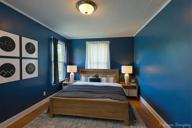 a bedroom with a bed and painting on the wall