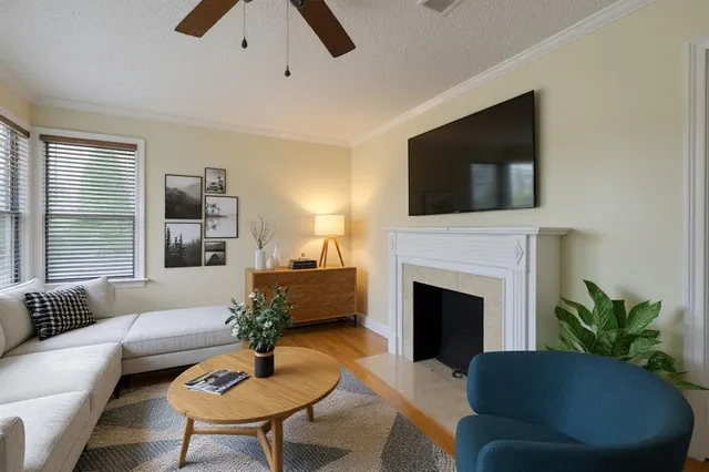 a living room with furniture a fireplace and a flat screen tv