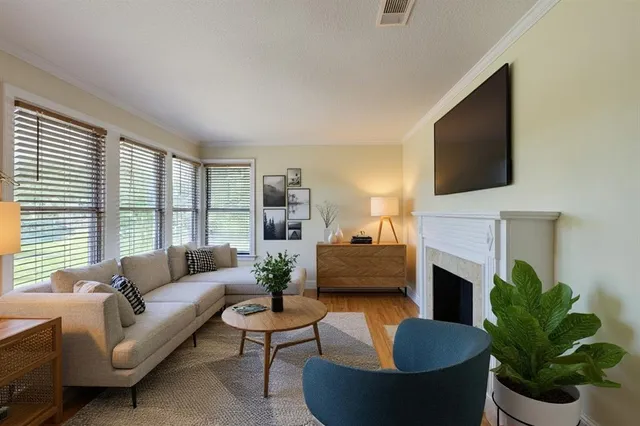 a living room with furniture a fireplace and a flat screen tv