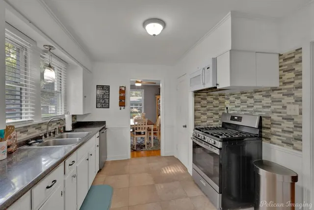 a kitchen with stainless steel appliances a stove sink and cabinets