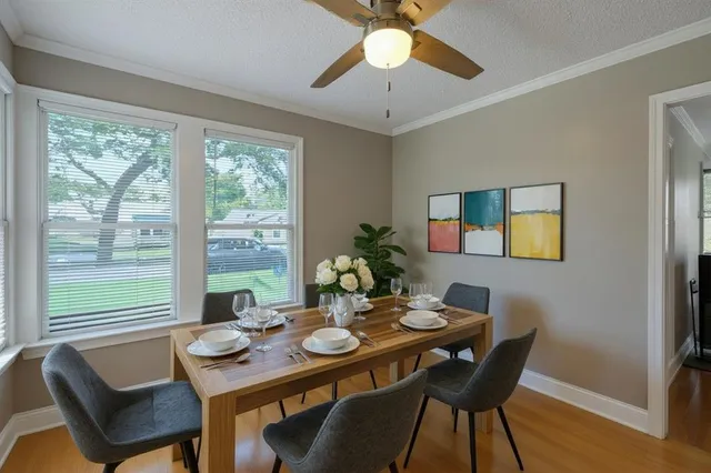 a view of a dining room with furniture window and wooden floor