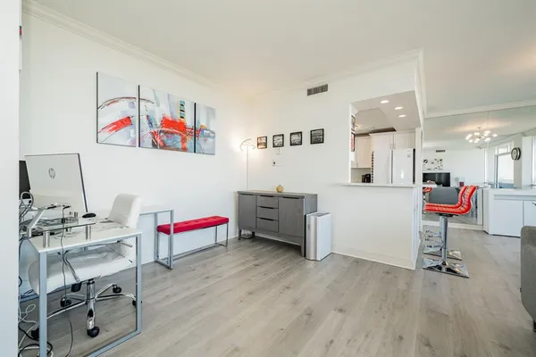 a living room with furniture and a kitchen