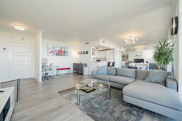 a living room with kitchen island and furniture