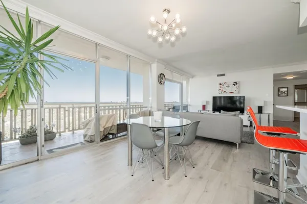 a living room with furniture and a view of kitchen
