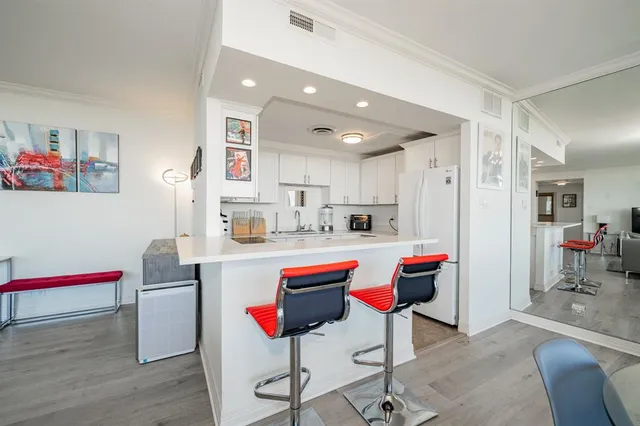 a living room with kitchen island and furniture