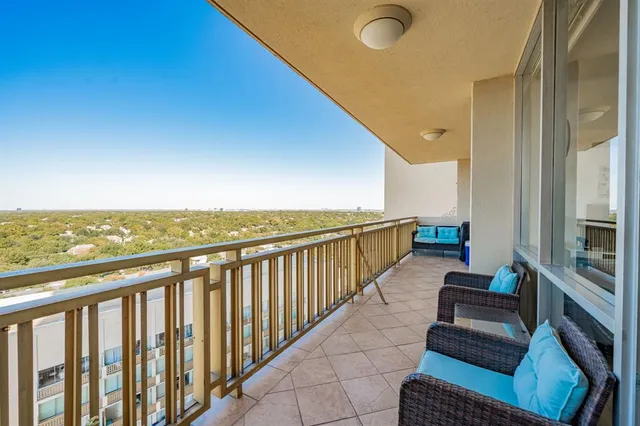 a view of roof deck with couches and ocean view