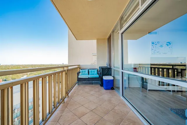 a view of a balcony with furniture