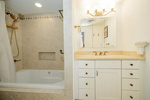 a bathroom with a shower sink and mirror