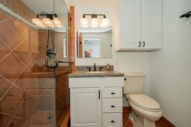a bathroom with a sink a toilet and vanity