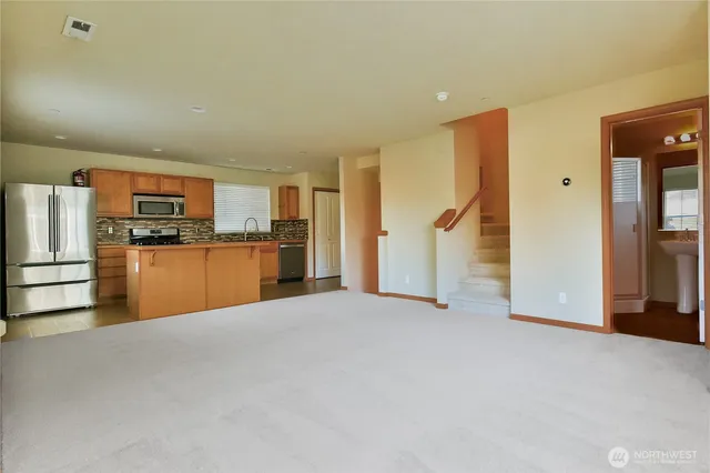 a view of a kitchen with a sink refrigerator and a kitchen