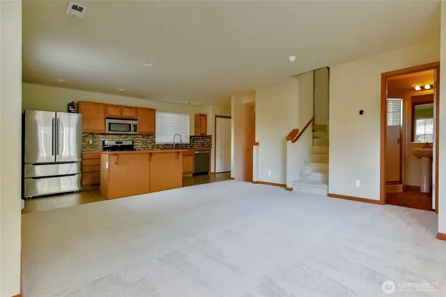 a view of a kitchen with refrigerator and microwave