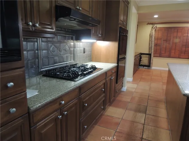 a kitchen with a stove and a refrigerator