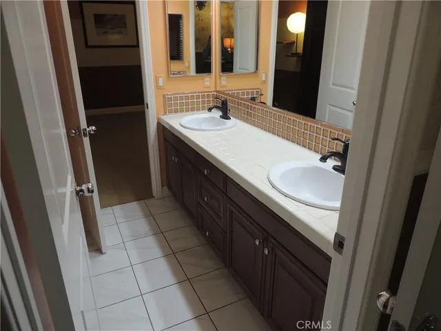 a bathroom with a double vanity sink and a mirror
