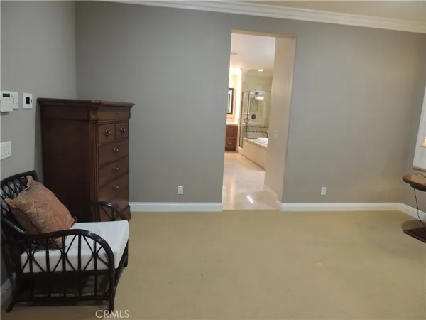 wooden floor in a hall with an entryway and a livingroom view