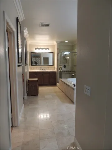 a large bathroom with a large mirror vanity and shower