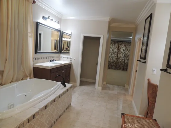 a bathroom with a tub sink and mirror